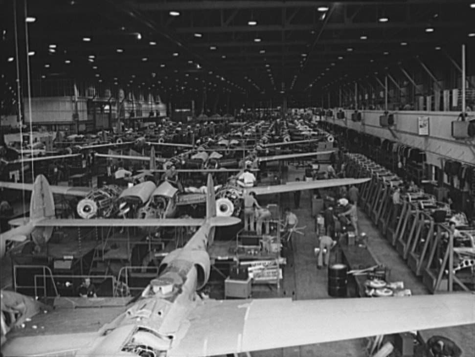 Rows of P-38 Lightnings under assembly on the vast factory floor at Lockheed's Burbank plant around 1942