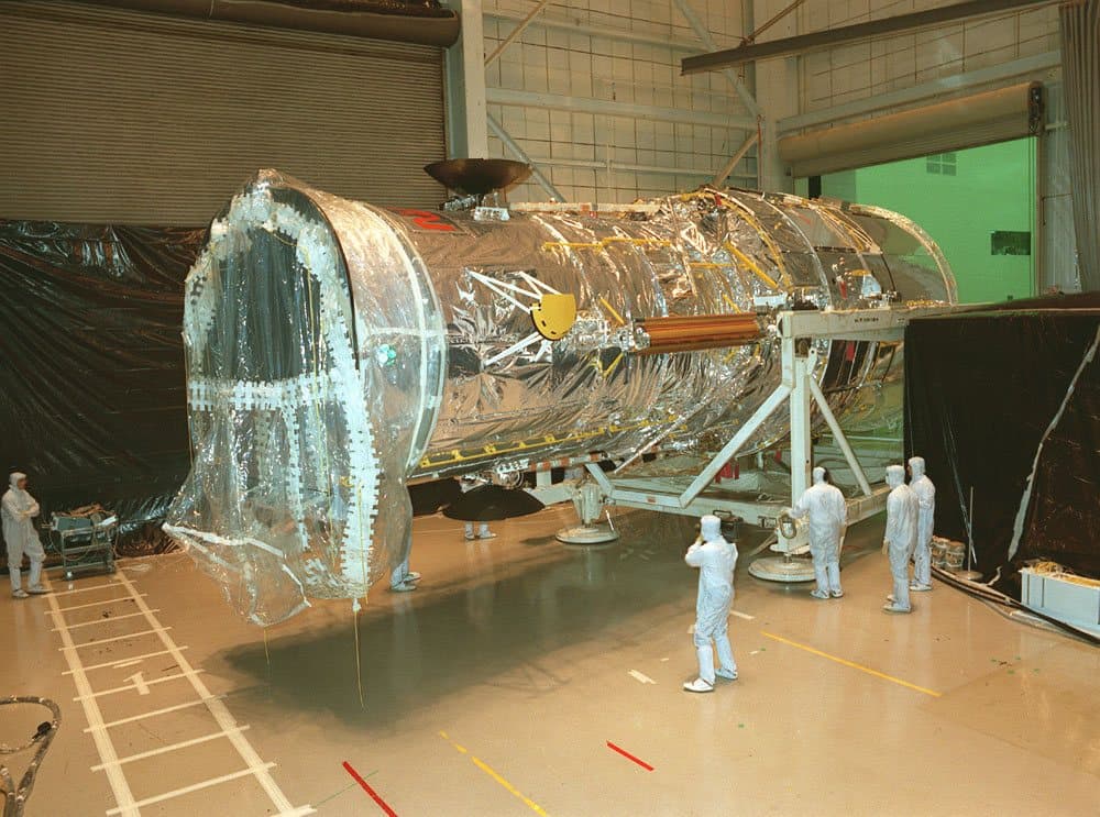 The Hubble Space Telescope being moved inside the Lockheed assembly plant before shipment to Kennedy Space Center